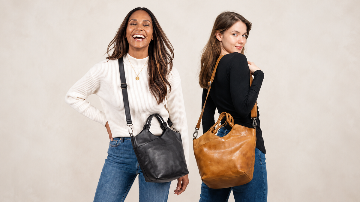 Two women wearing the Nash Leather Tote Crossbody Bag by Latico Leathers in black and tan